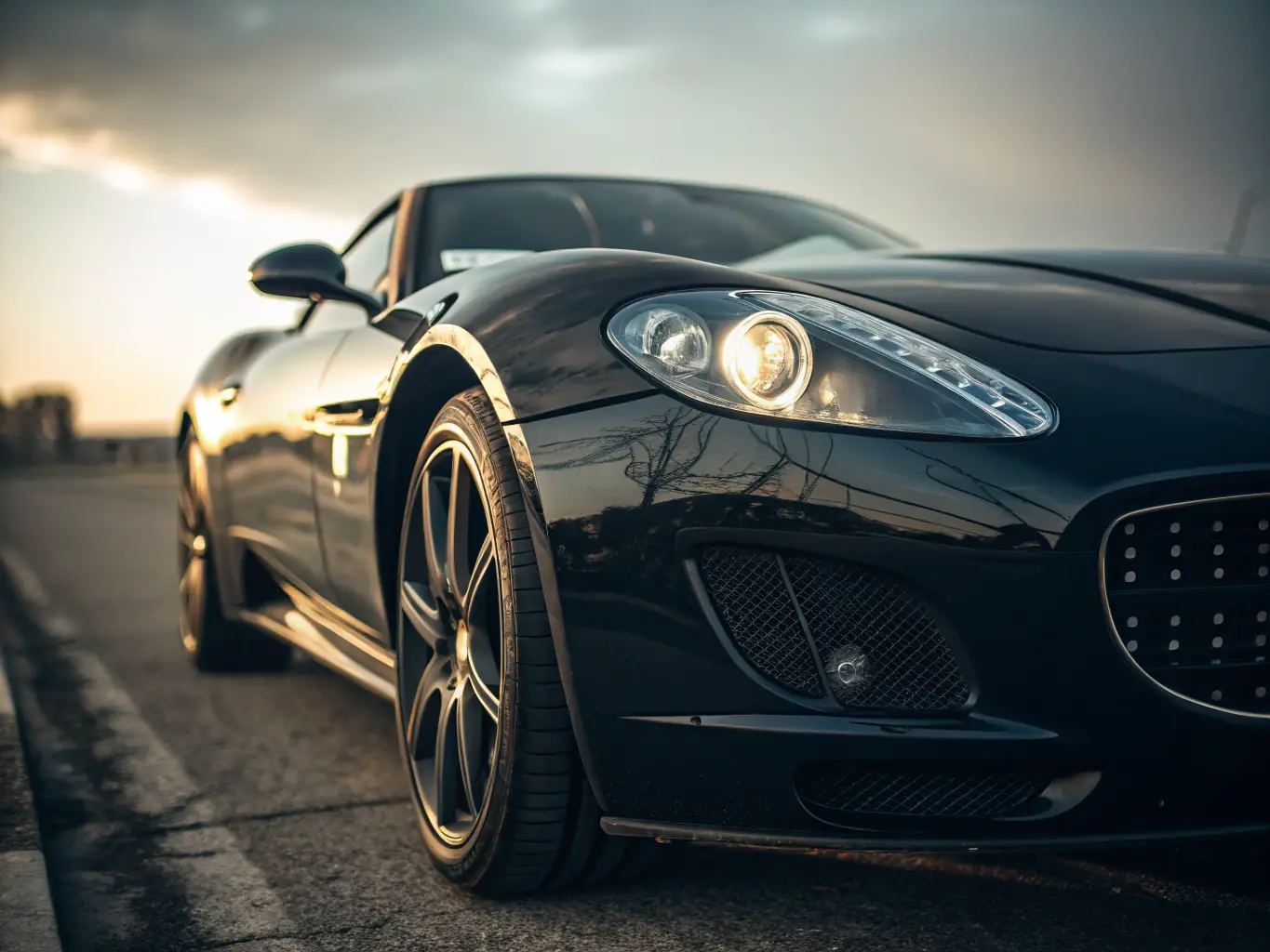 A gleaming, freshly washed car with water droplets beading on its surface, showcasing the effectiveness of Turbo Sphere's Full Exterior Wash service.